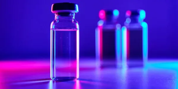 Peptide vials in blue and pink light